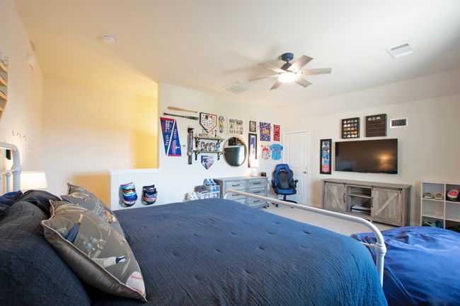 Bedroom with visible vents and ceiling fan | Image 28