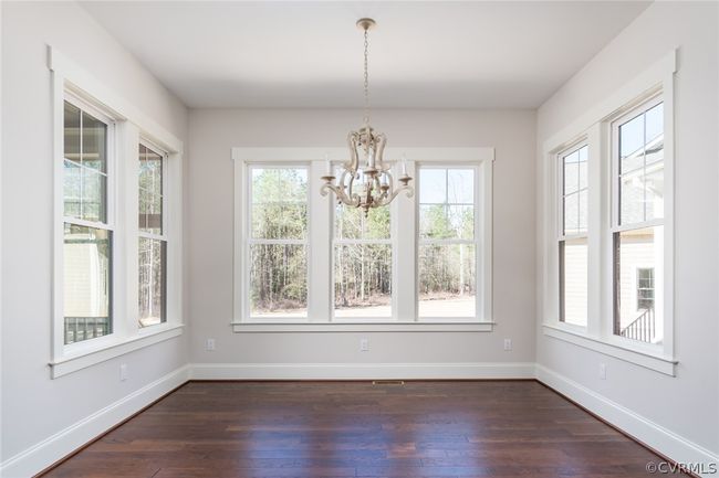 Unfurnished dining area featuring an inviting chandelier and hardwood / wood-style floors | Image 6