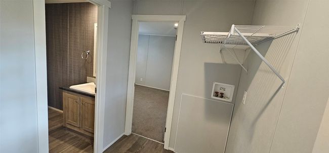 Laundry area featuring washer hookup and dark wood-style flooring | Image 8