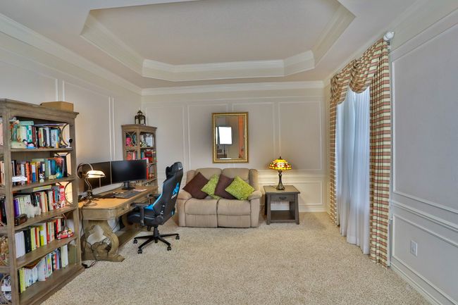 Office space featuring a decorative wall, carpet floors, ornamental molding, and a tray ceiling | Image 12