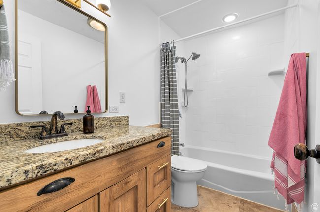 Bathroom with vanity and shower / bathtub combination with curtain | Image 10