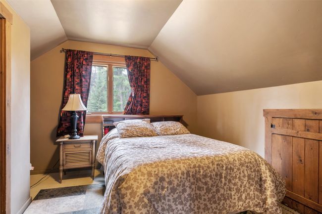 Bedroom featuring lofted ceiling and baseboards | Image 54