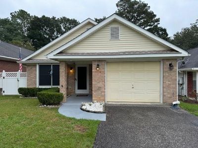 View of front of home featuring a garage and a front yard | Image 1