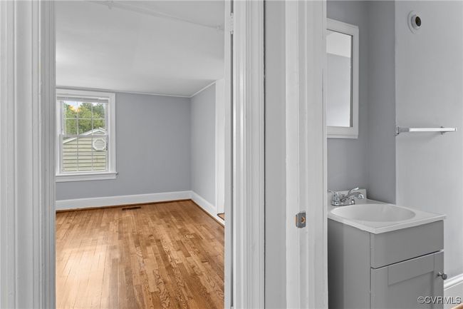 Bathroom featuring vanity, visible vents, wood finished floors, and baseboards | Image 21