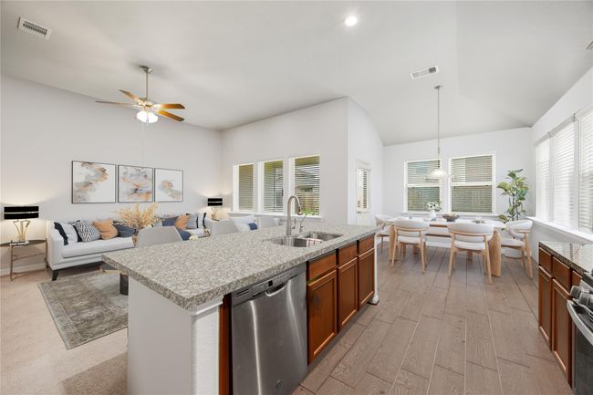 Charming and functional kitchen featuring classic cabinetry, modern appliances, and a layout ideal for both cooking and conversation. *Virtually Staged | Image 11