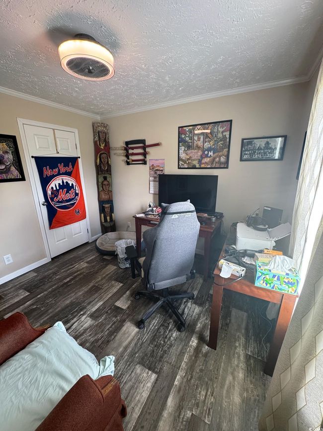 Office space featuring ornamental molding, wood finished floors, and a textured ceiling | Image 26