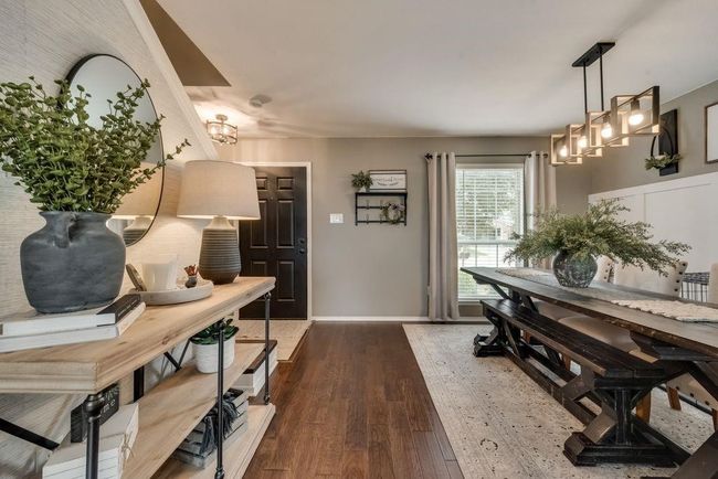 Dining room with a chandelier and dark wood-style flooring | Image 5