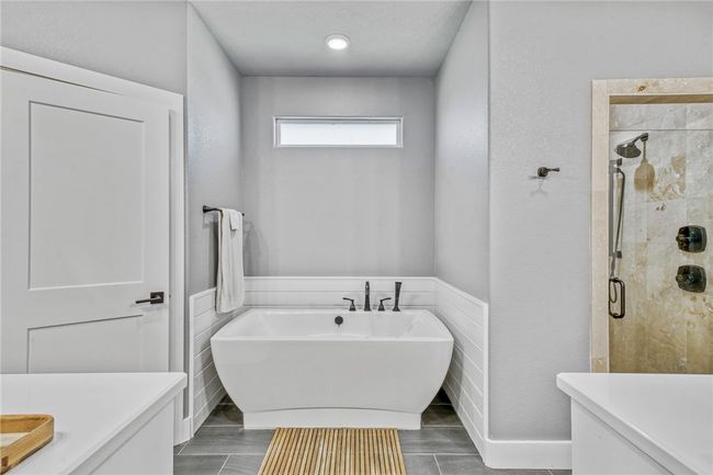 Bathroom with vanity and shower with separate bathtub | Image 24