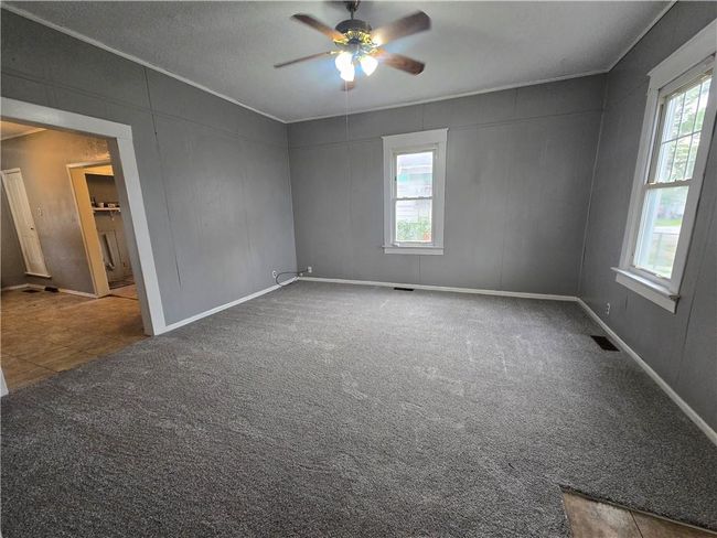 Carpeted spare room with ceiling fan and baseboards | Image 23