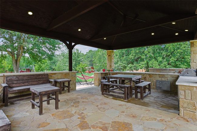 View of patio / terrace featuring grilling area, outdoor dry bar, and exterior kitchen | Image 24