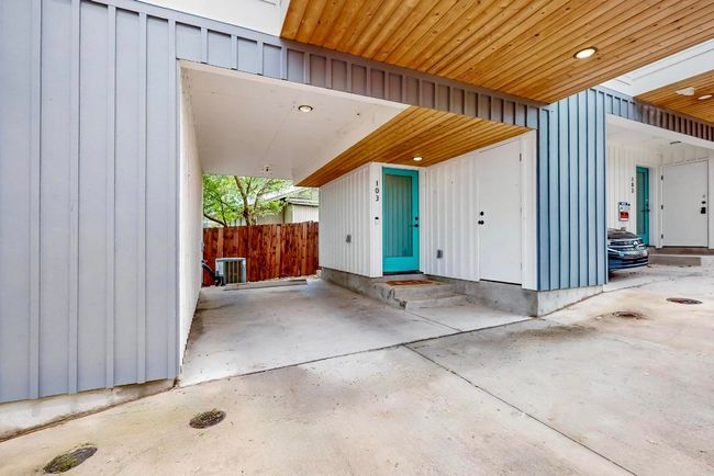 Doorway to property with board and batten siding and central AC | Image 28