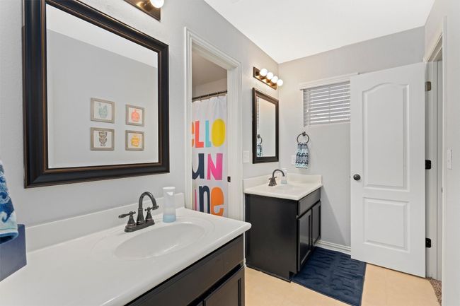 Bathroom with two vanities and tile patterned floors | Image 27