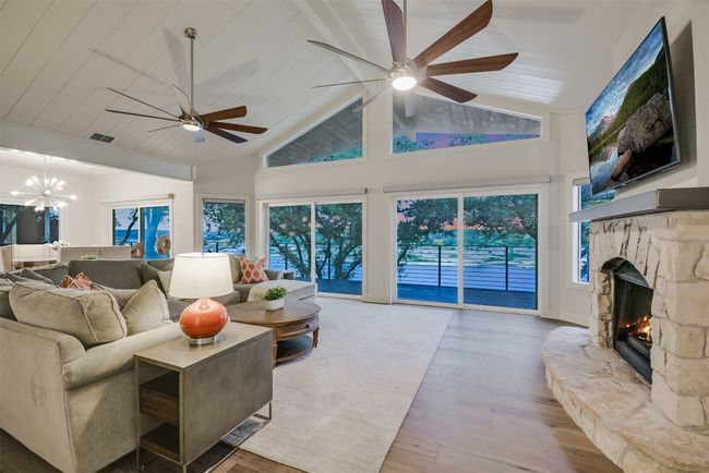The open-concept layout seamlessly connects the living room to the kitchen and dining area, perfect for entertaining guests | Image 8