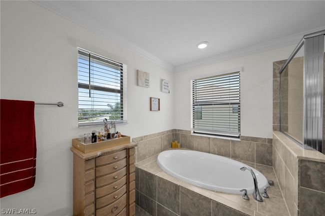 Bathroom featuring crown molding and separate shower and tub | Image 42