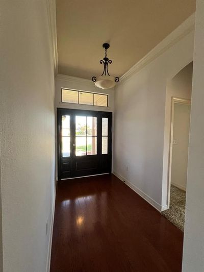 Spare room featuring crown molding and dark hardwood / wood-style floors | Image 2