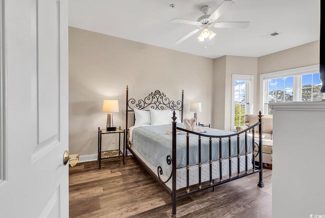 Bedroom with visible vents, baseboards, ceiling fan, and wood finished floors | Image 18