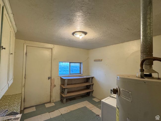 Utility room featuring gas water heater | Image 21