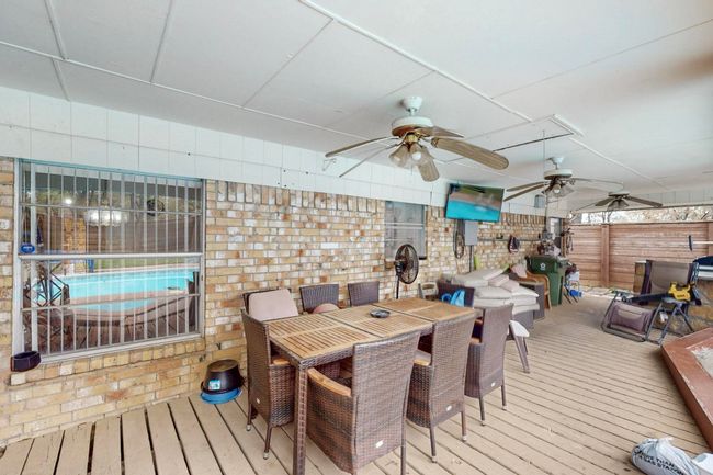 Wooden deck featuring outdoor dining area and ceiling fan | Image 31