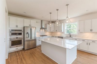 (Photo of an inventory home actual homes finishes will vary) Welcome to the Snelling! This spacious gourmet kitchen features a large center island, quartz countertops, LVP floors, stainless appliances and more. | Image 2