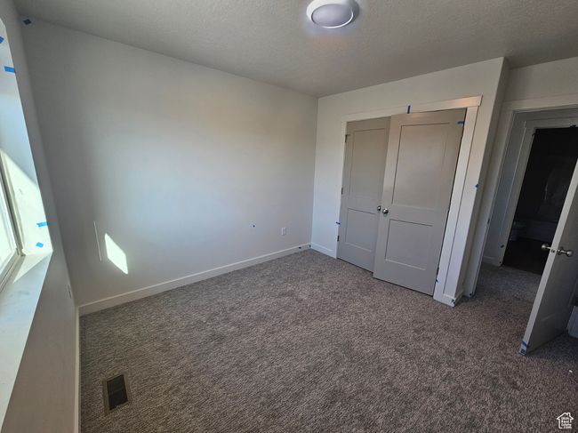 Unfurnished bedroom with carpet and a closet | Image 25