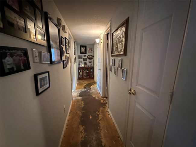 Hallway featuring concrete floors and a textured ceiling | Image 8