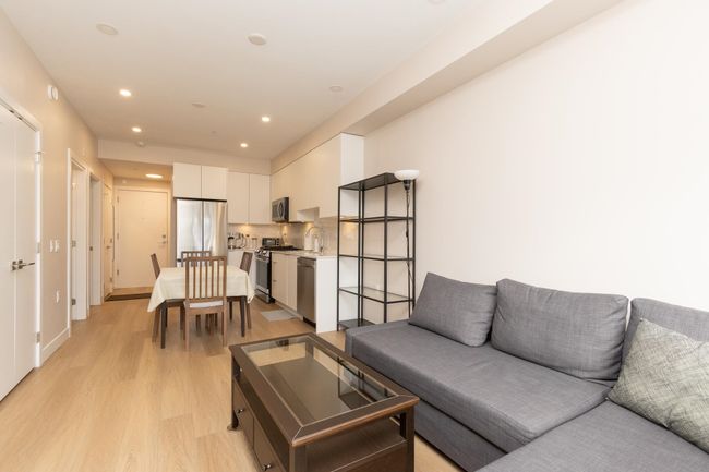 Living area with light wood-style flooring and recessed lighting | Image 6