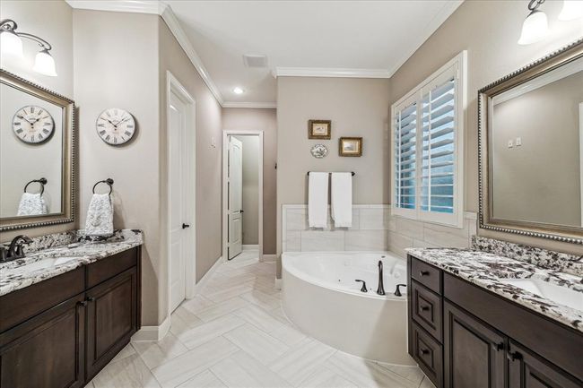 Two separate sinks, corner jetted tub and stand alone shower in the primary ensuite. | Image 17