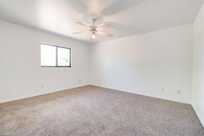 Carpeted spare room with baseboards and a ceiling fan | Image 22