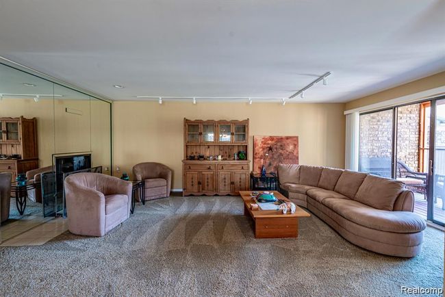 Carpeted living area featuring rail lighting | Image 8