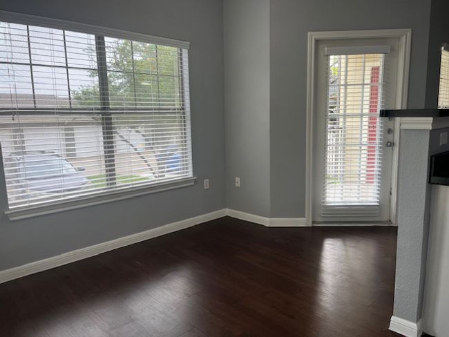 Unfurnished room with baseboards and dark wood-style flooring | Image 13