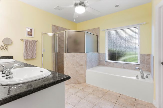 Primary bath with large walk in shower, his/hers sinks and jetted soaking tub. | Image 20