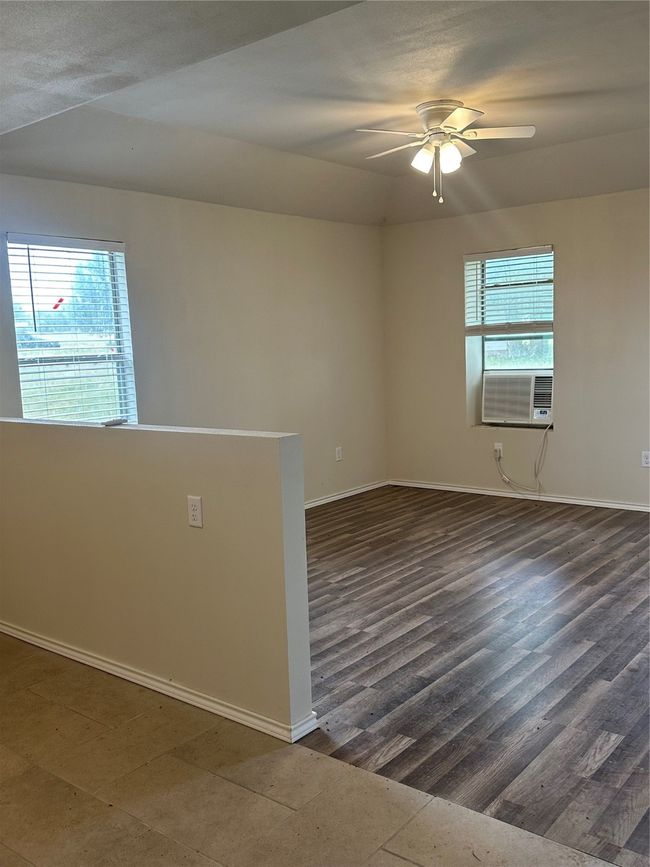 Empty room featuring healthy amount of natural light, ceiling fan, and baseboards | Image 15