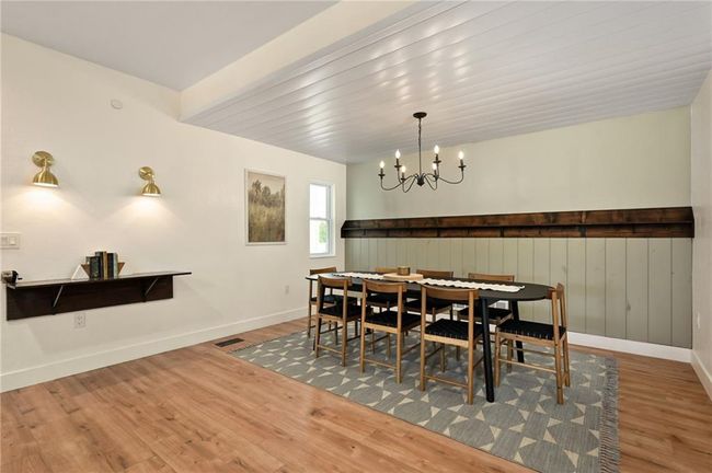 Dining space featuring wood LVP floors, an elegant chandelier. Entertaining is perfect in this space. | Image 20