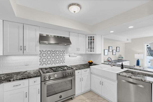 Updated kitchen with granite, beautiful two-bay farm sink, and a 5-burner that was made in Italy. | Image 13