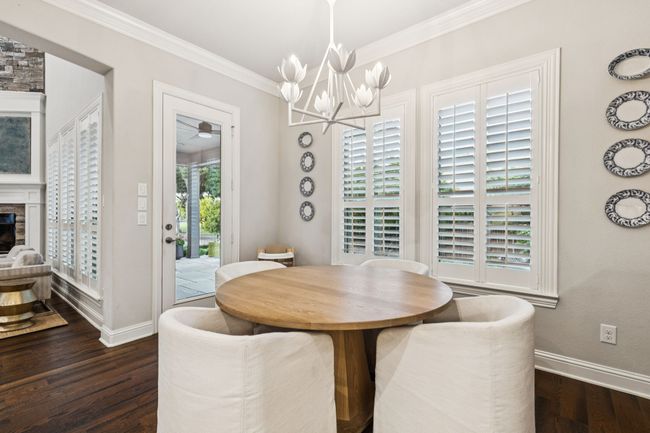 Dining area off kitchen adorned with Julie Neill Alberto Chandelier | Image 17