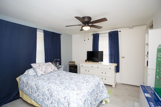 Bedroom featuring light wood-type flooring and ceiling fan | Image 26