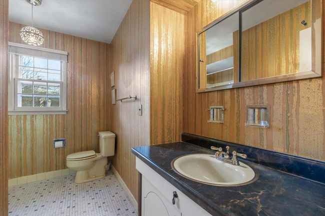 Bathroom with baseboards, vanity, and toilet | Image 22