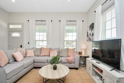 Tall ceilings showcase this HISTORIC HOME!! Notice the transom window and all the updated tall windows! A current successful short term rental, this home is set up and READY TO GO for your beach getaway or short term or long term investment! | Image 2