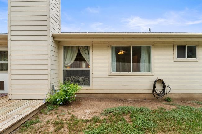View of side of home with a wooden deck and a chimney | Image 37