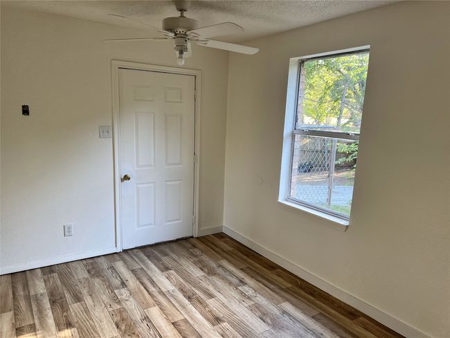 Unfurnished room with light wood-style floors, and ceiling fan | Image 6