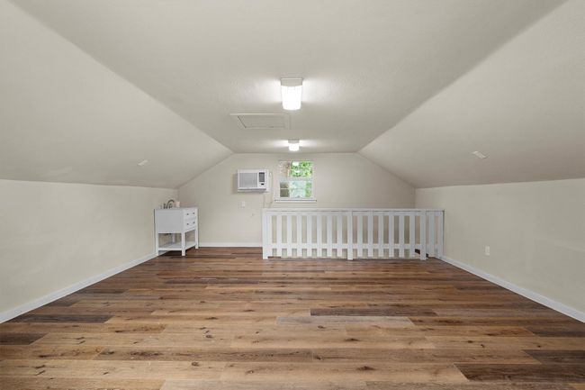 This upstairs room over the detached garage is 384 sf. It is finished out, has a sink and wall ac unit. | Image 38