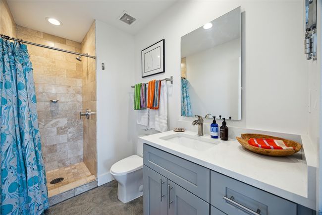 Full bath featuring vanity, tiled shower, and recessed lighting | Image 20