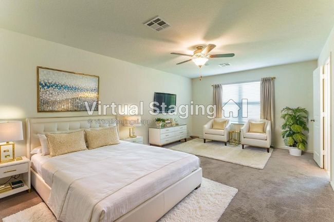 Virtually Staged- primary, Carpeted bedroom with visible vents, baseboards, and a ceiling fan | Image 11