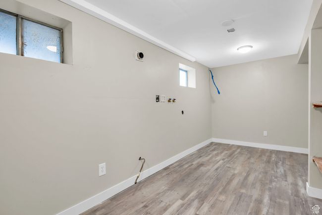 Interior space featuring wood finished floors and baseboards | Image 24