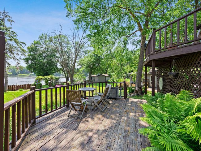 The outdoor spaces are a true highlight. A two-tiered wooden deck offers expansive areas for relaxing, grilling, or entertaining. | Image 12