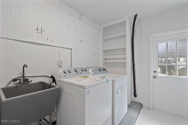 Laundry area with laundry area, washing machine and dryer, and a sink | Image 11