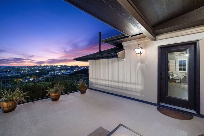 Patio terrace at dusk featuring a balcony | Image 36