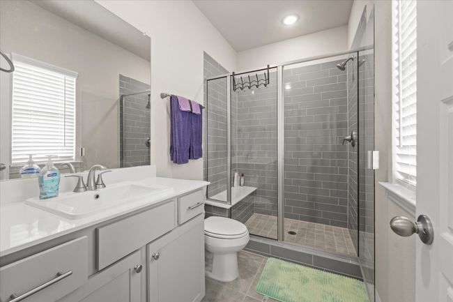 Full bathroom featuring vanity, a shower stall, tile patterned floors, and recessed lighting | Image 20