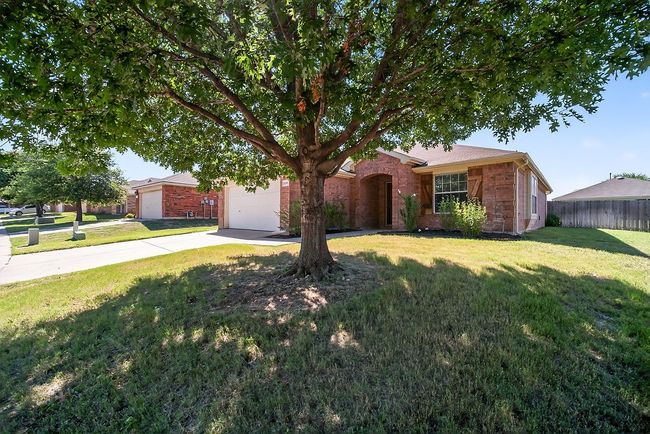 View of front of home featuring a garage, driveway, and brick siding | Image 6