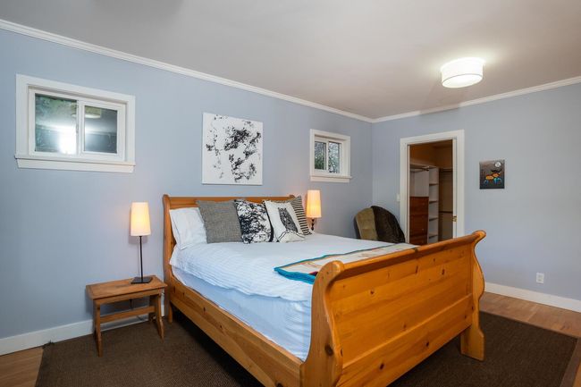 Bedroom featuring crown molding, a spacious closet, and baseboards | Image 17
